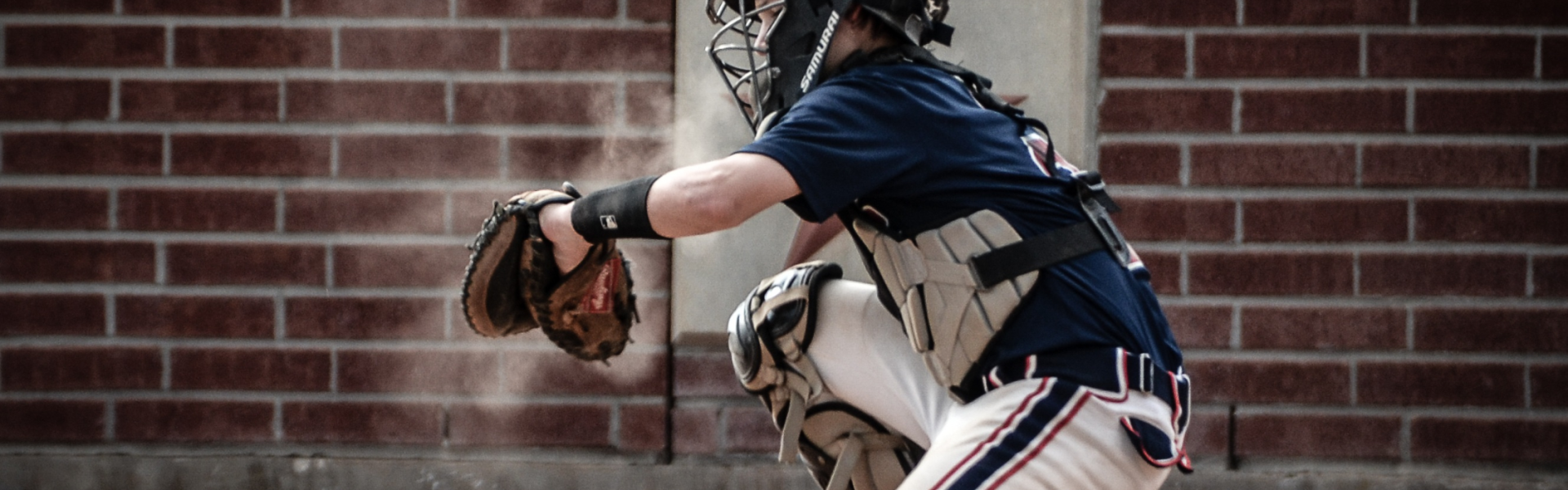 Image of a youth catching a baseball.
