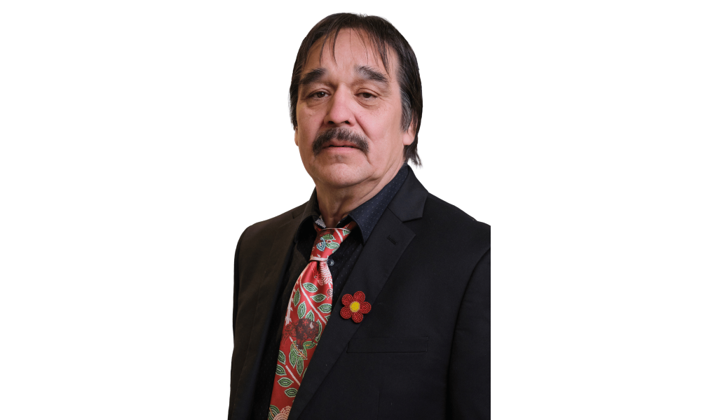Headshot of a man in a dark suit with red tie.