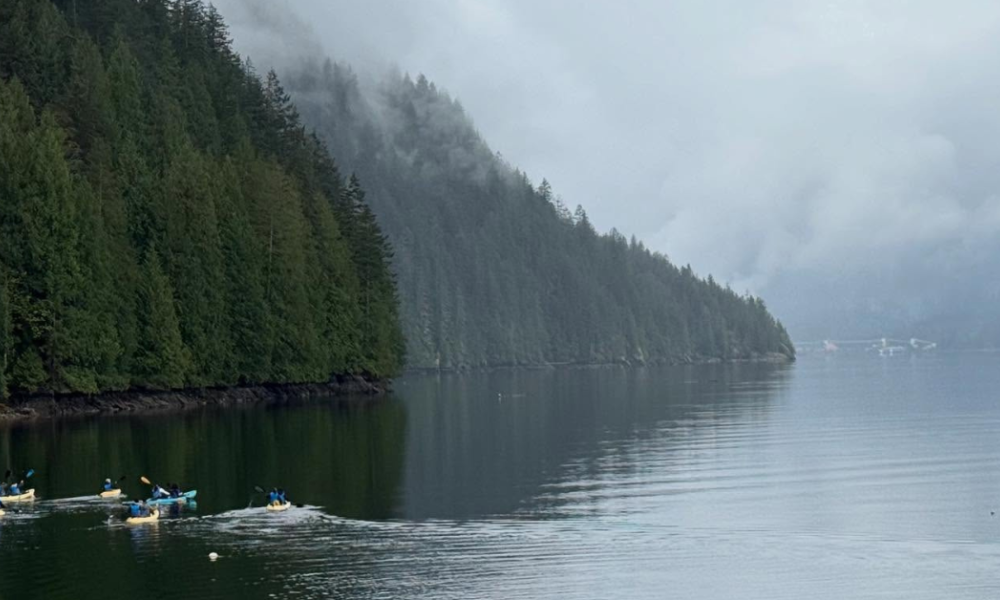 A group of paddlers on the ocean at Camp Latona