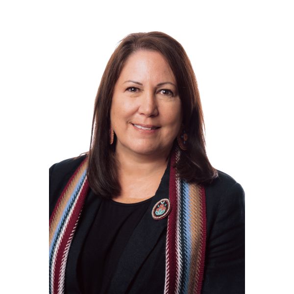 Headshot of a woman wearing a dark shirt and Metis sash around her shoulders.