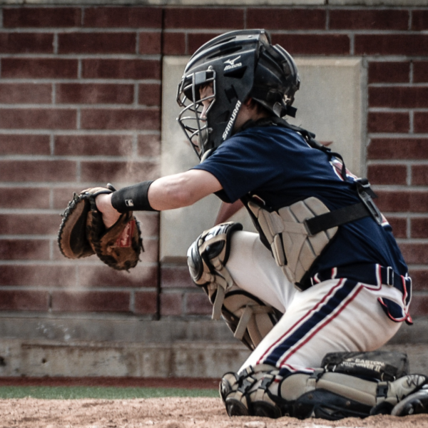 Image of a youth catching a baseball.