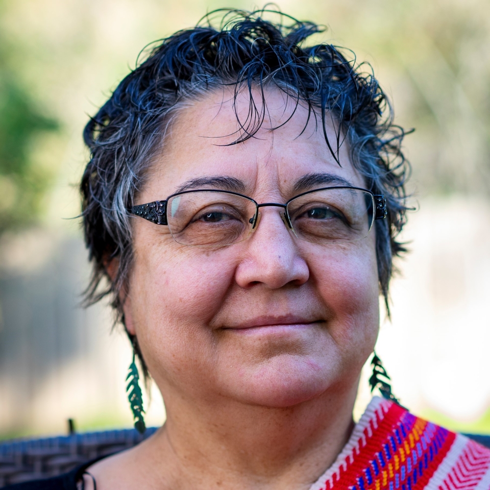 Headshot of a woman wearing a Metis sash.