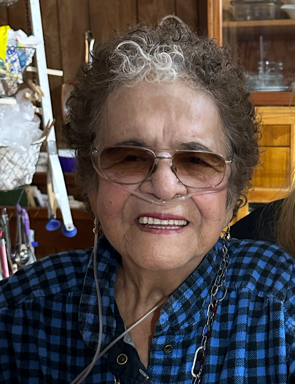 A smiling elderly woman in a black jacket.