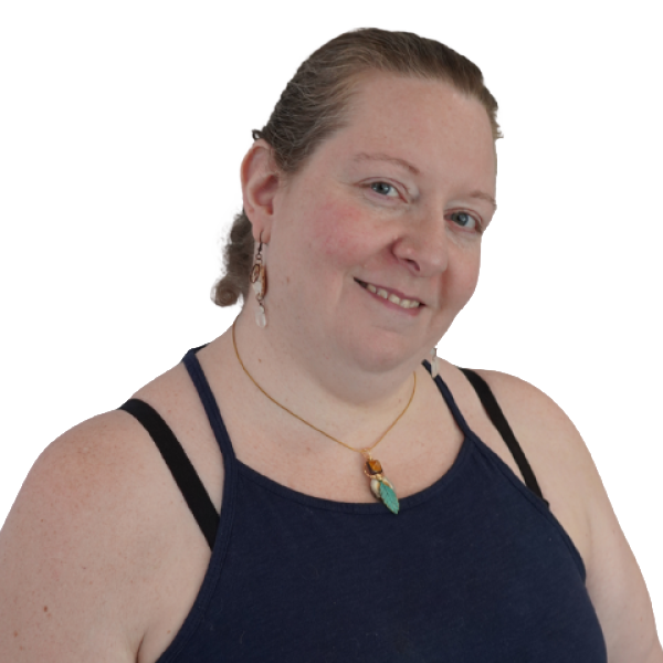 Anya McVean is smiling in a black tank top with a green necklace against a white background.