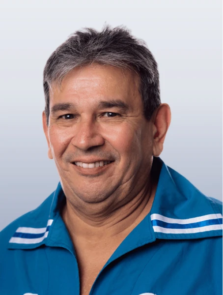 Allan Lavallee is smiling in a blue shirt with the Métis infinity logo against a white background.